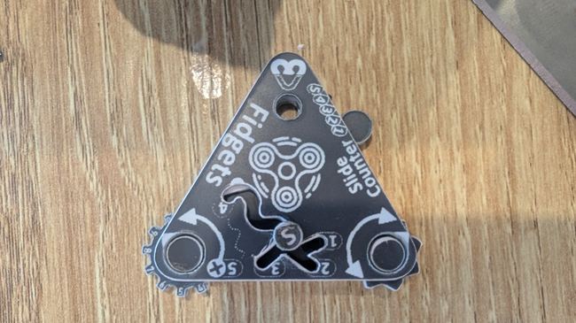 Custom fidget boredom-buster tag with spinning elements